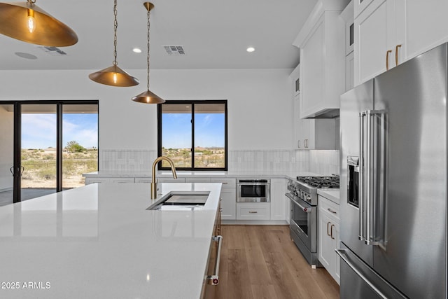 34198 S State Route 89th Hwy, Wickenburg, AZ 85390 - kitchen with high quality appliances, a sink, recessed lighting, tasteful backsplash, and light wood-type flooring