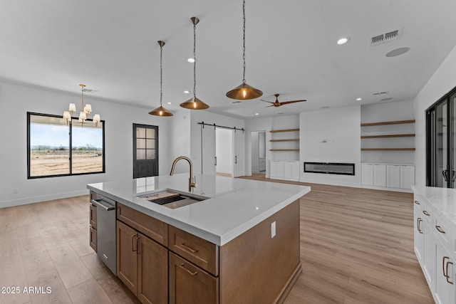 34198 S State Route 89th Hwy, Wickenburg, AZ 85390 - kitchen with a sink, a barn door, a ceiling fan, a center island with sink, and recessed lighting