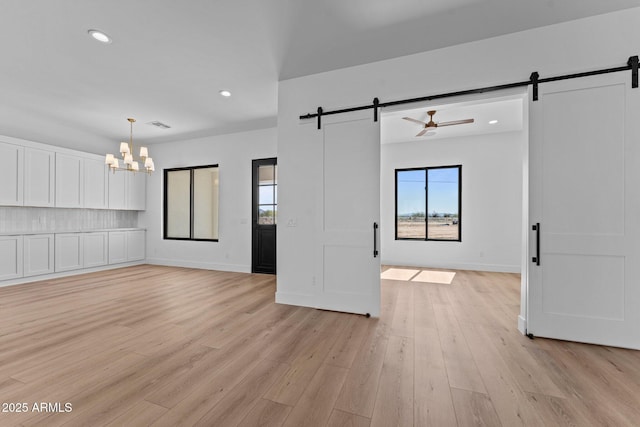 34198 S State Route 89th Hwy, Wickenburg, AZ 85390 - unfurnished living room featuring a barn door, a chandelier, recessed lighting, light wood finished floors, and ceiling fan