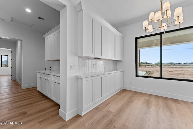 34198 S State Route 89th Hwy, Wickenburg, AZ 85390 - unfurnished dining area with baseboards, a chandelier, light wood finished floors, and recessed lighting