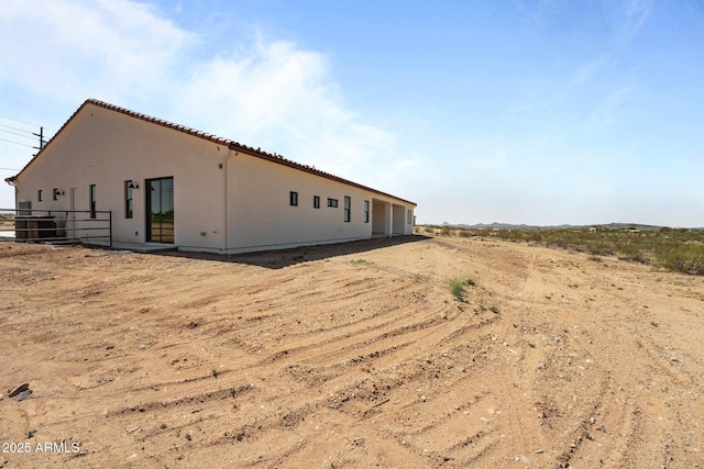 34198 S State Route 89th Hwy, Wickenburg, AZ 85390 - view of home's exterior with stucco siding, cooling unit, and a tile roof
