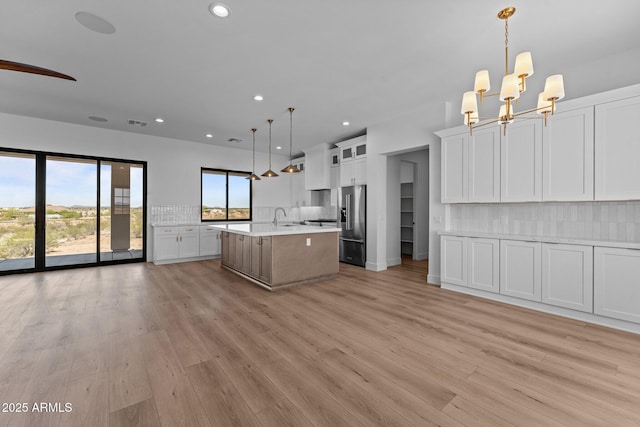 34198 S State Route 89th Hwy, Wickenburg, AZ 85390 - kitchen with high quality fridge, light countertops, tasteful backsplash, recessed lighting, and a sink