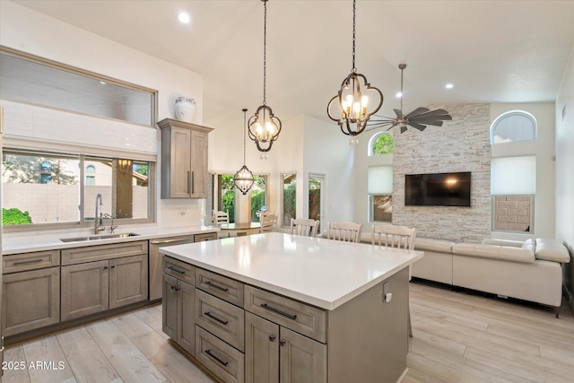 13361 N 99th Pl, Scottsdale, AZ 85260 - kitchen with a sink, light wood-type flooring, a chandelier, healthy amount of natural light, and high vaulted ceiling