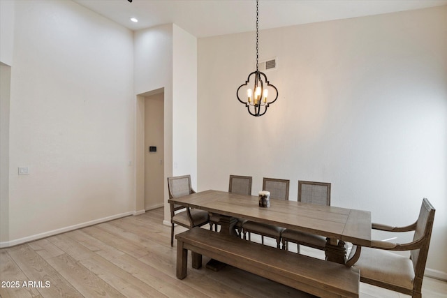 13361 N 99th Pl, Scottsdale, AZ 85260 - dining space featuring light wood-style floors, baseboards, a chandelier, a towering ceiling, and recessed lighting
