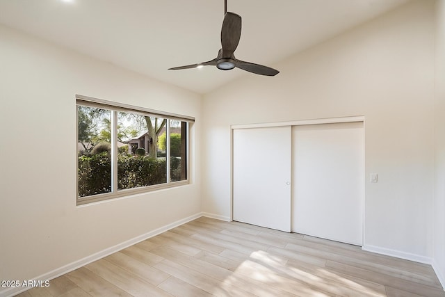 13361 N 99th Pl, Scottsdale, AZ 85260 - unfurnished bedroom with light wood-style floors, baseboards, lofted ceiling, a closet, and ceiling fan