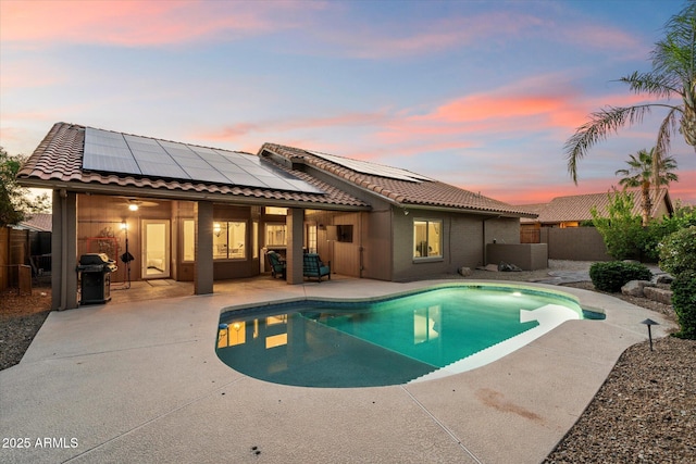13361 N 99th Pl, Scottsdale, AZ 85260 - pool at dusk featuring a patio area, area for grilling, and a fenced backyard