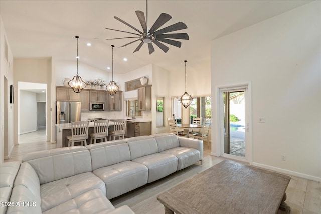13361 N 99th Pl, Scottsdale, AZ 85260 - living room featuring a chandelier, high vaulted ceiling, a ceiling fan, baseboards, and recessed lighting