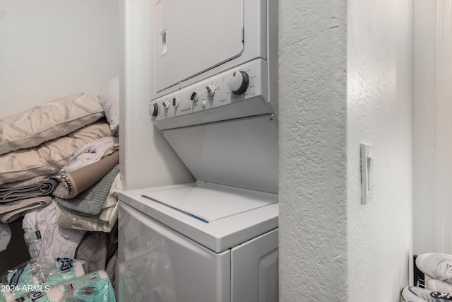 laundry room with stacked washer / dryer