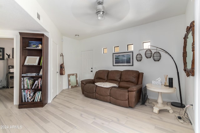 living room with light hardwood / wood-style flooring and ceiling fan