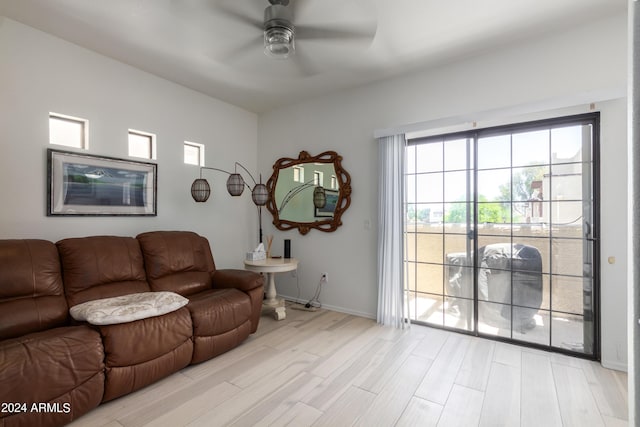 living room with ceiling fan and light hardwood / wood-style floors