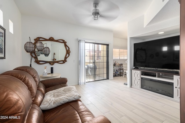 living room featuring ceiling fan and light hardwood / wood-style floors