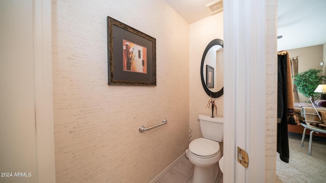 bathroom featuring tile patterned flooring and toilet