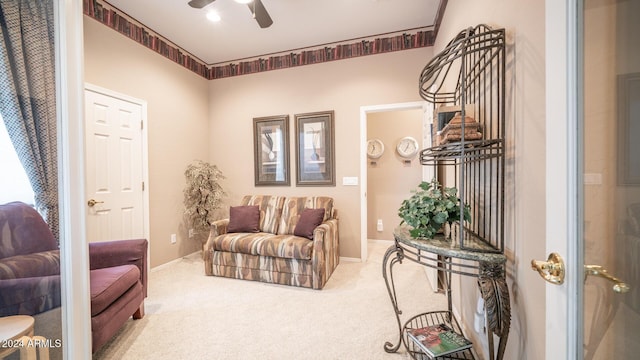 carpeted living room featuring ceiling fan