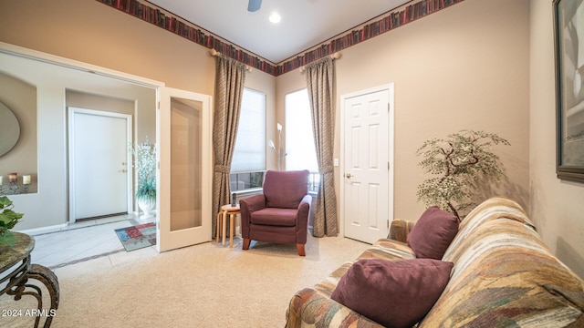 sitting room featuring ceiling fan and french doors