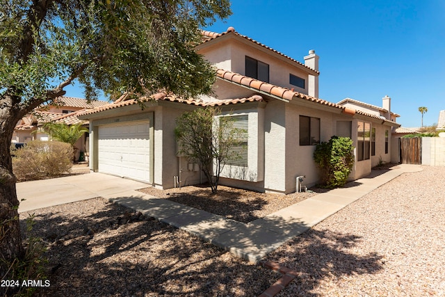 mediterranean / spanish-style home with a garage