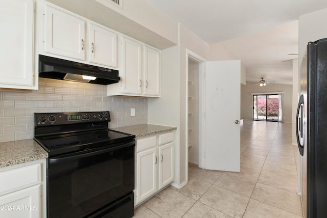 kitchen with light stone countertops, black range with electric stovetop, white cabinetry, fridge, and ceiling fan