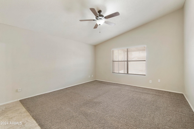 tiled empty room with vaulted ceiling and ceiling fan