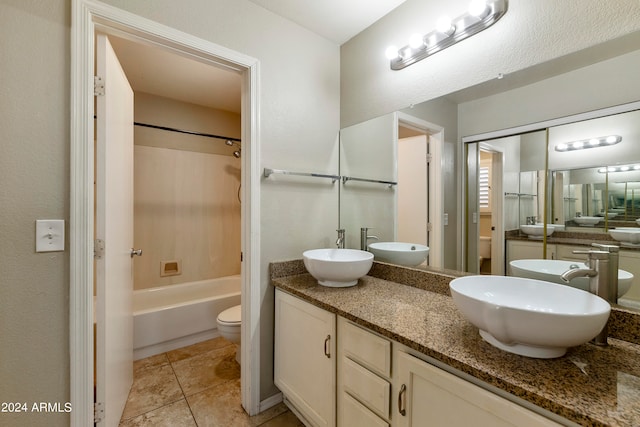 full bathroom featuring vanity, toilet, tile patterned floors, and shower / washtub combination