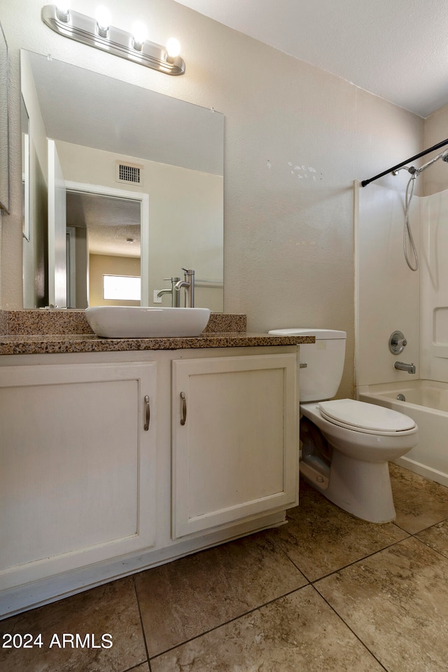 full bathroom with tile patterned floors, vanity, toilet, and tub / shower combination