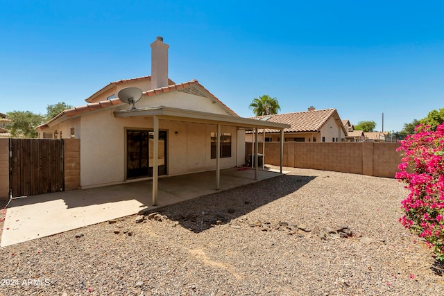 back of house with a patio