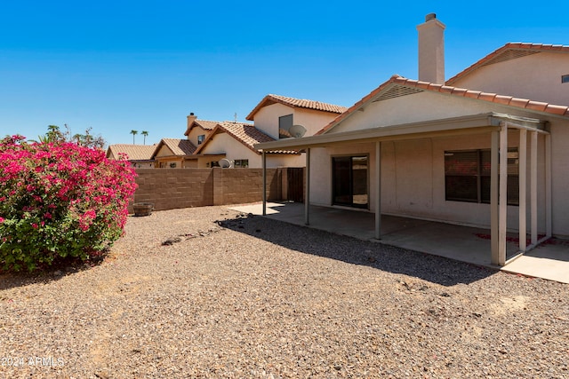 back of house with a patio