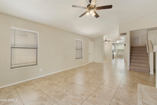 tiled empty room with ceiling fan