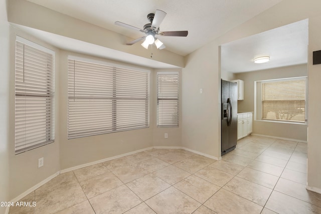 tiled empty room featuring ceiling fan