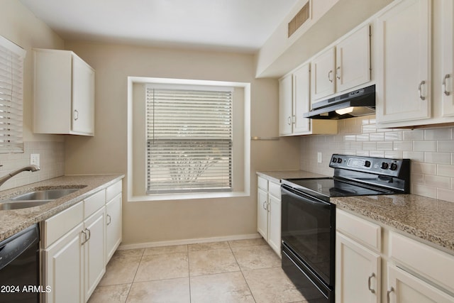 kitchen with light stone countertops, black appliances, light tile patterned floors, sink, and white cabinets