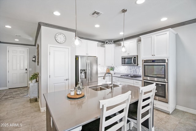 kitchen with a sink, baseboards, backsplash, and stainless steel appliances