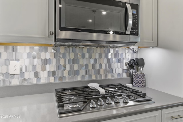 kitchen with appliances with stainless steel finishes and tasteful backsplash