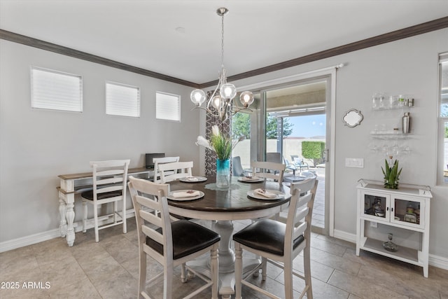 dining area with baseboards, ornamental molding, a wealth of natural light, and a chandelier