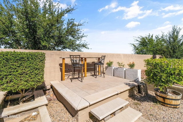 view of patio / terrace featuring fence