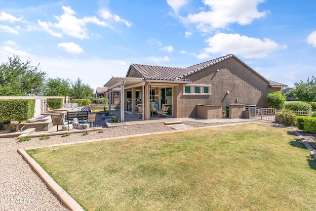 rear view of property featuring fence, a pergola, a patio area, and a tile roof