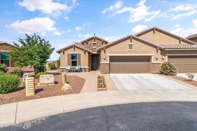 craftsman inspired home with an attached garage, stucco siding, stone siding, and concrete driveway
