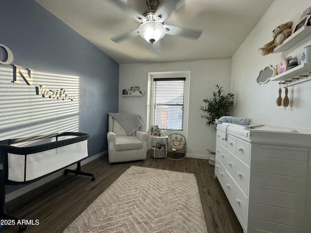 living area featuring a ceiling fan, wood finished floors, and baseboards