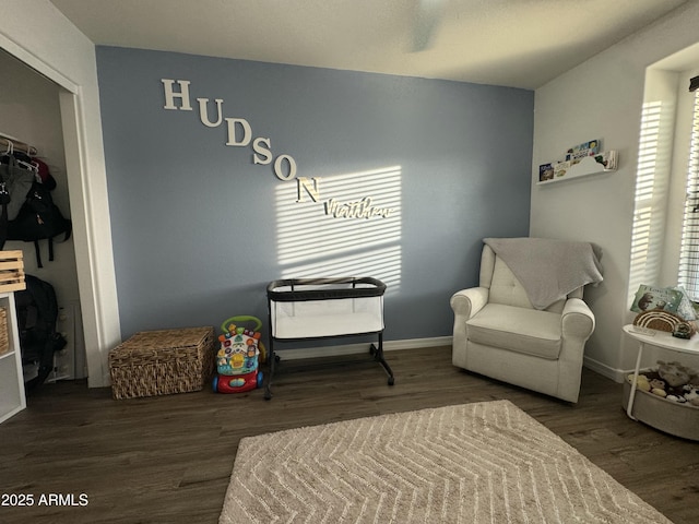 sitting room with baseboards and wood finished floors