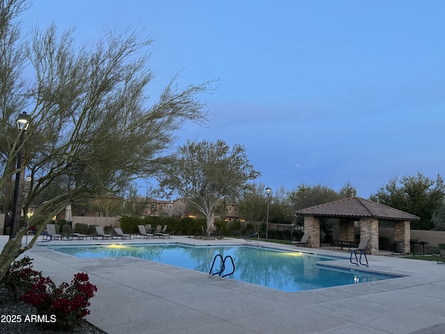 pool featuring a gazebo, a patio, and fence