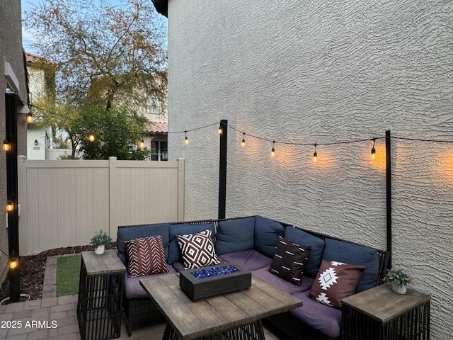 view of patio / terrace featuring an outdoor living space and fence