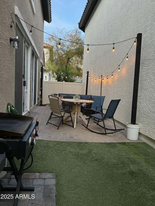 view of patio / terrace with outdoor dining space, a grill, and fence