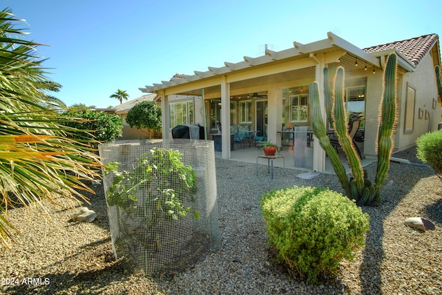 rear view of house featuring central air condition unit, ceiling fan, and a patio