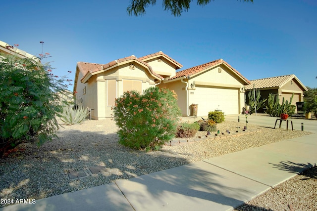 mediterranean / spanish-style house with a garage