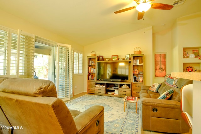 living room with hardwood / wood-style floors, lofted ceiling, and ceiling fan