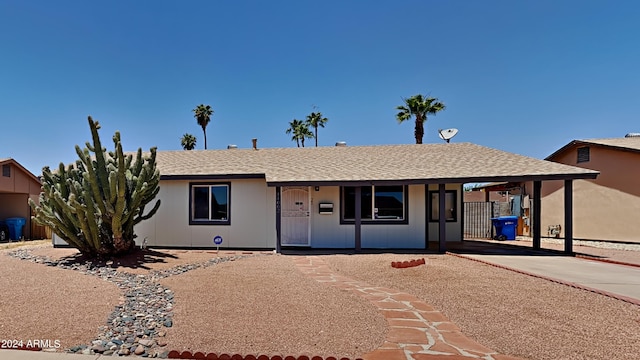 single story home featuring a porch and a carport