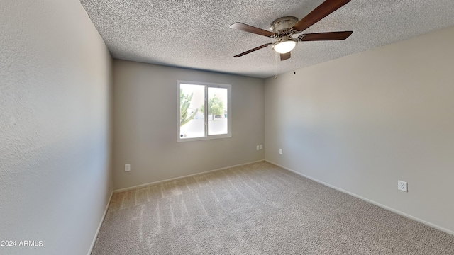 unfurnished room featuring ceiling fan, light colored carpet, and a textured ceiling