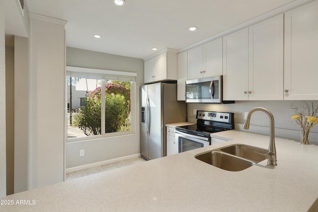 kitchen with white cabinetry, sink, and stainless steel appliances