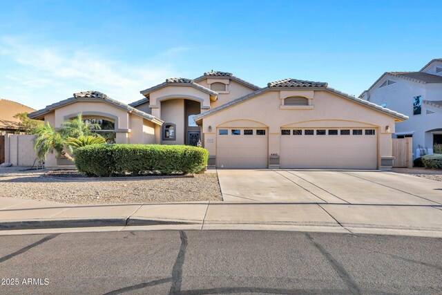 4493 E Desert Sands Dr, Chandler, AZ 85249 - mediterranean / spanish home featuring a garage, concrete driveway, stucco siding, and a tile roof