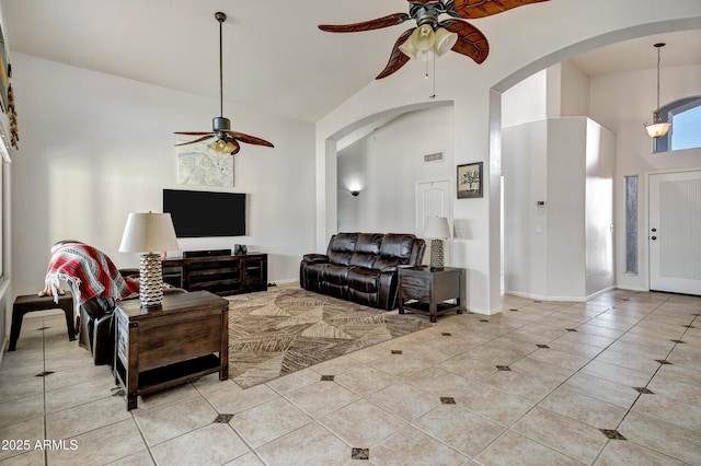 4493 E Desert Sands Dr, Chandler, AZ 85249 - living room featuring ceiling fan, high vaulted ceiling, light tile patterned floors, arched walkways, and baseboards