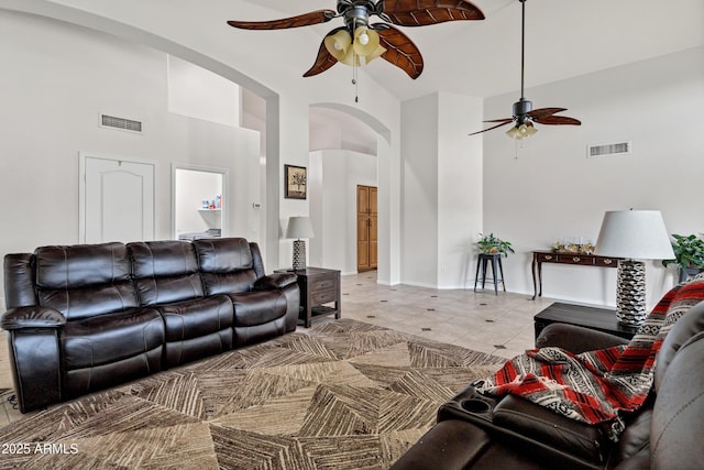 4493 E Desert Sands Dr, Chandler, AZ 85249 - living area featuring a ceiling fan, arched walkways, high vaulted ceiling, light tile patterned floors, and baseboards
