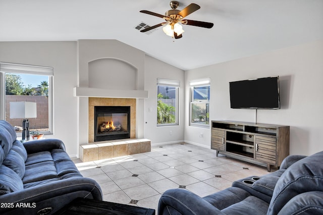 4493 E Desert Sands Dr, Chandler, AZ 85249 - living room with lofted ceiling, ceiling fan, a tile fireplace, light tile patterned floors, and baseboards