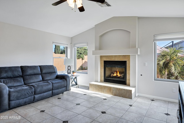 4493 E Desert Sands Dr, Chandler, AZ 85249 - living area with ceiling fan, a tiled fireplace, lofted ceiling, light tile patterned flooring, and baseboards